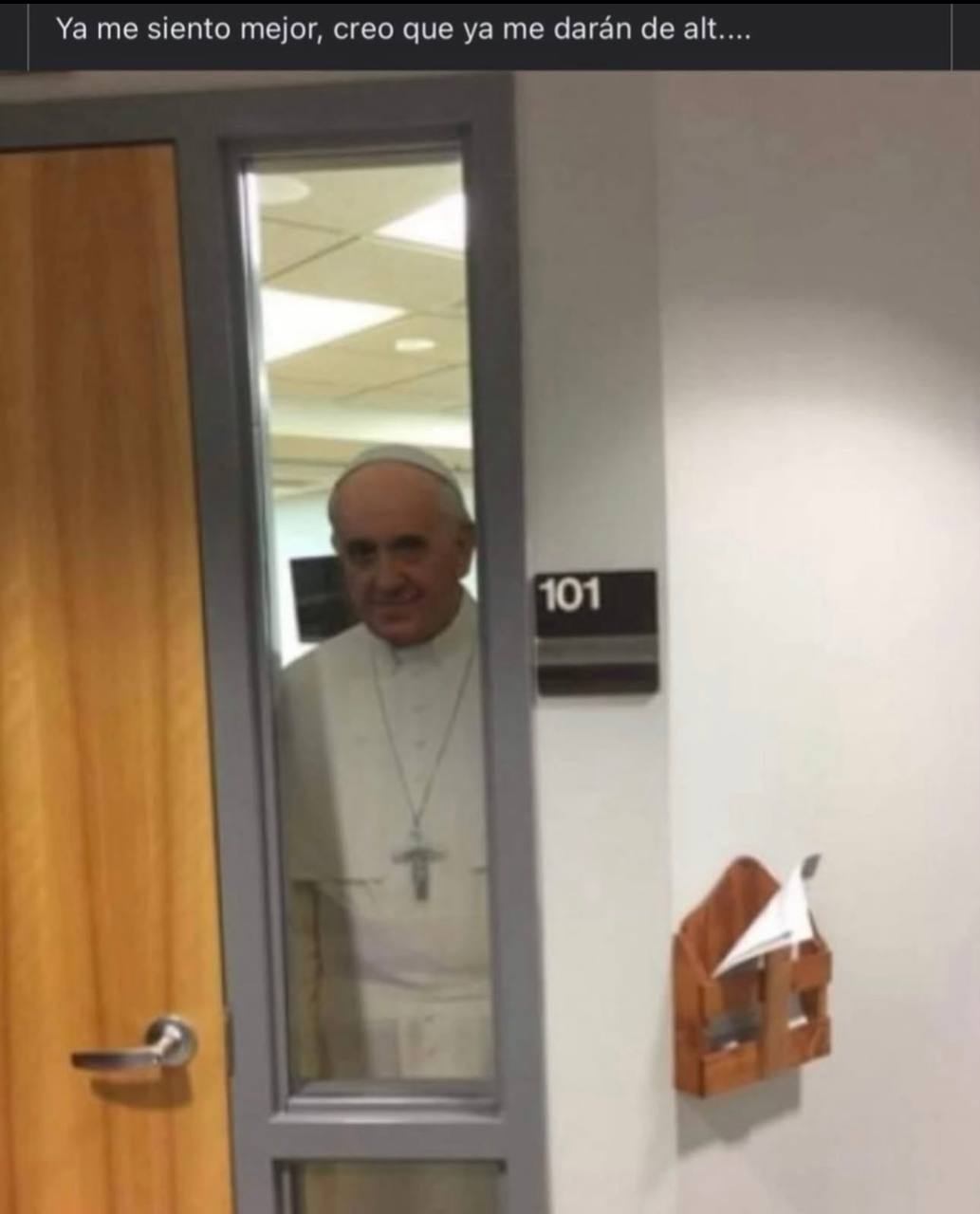 a man in a white shirt is looking at the door